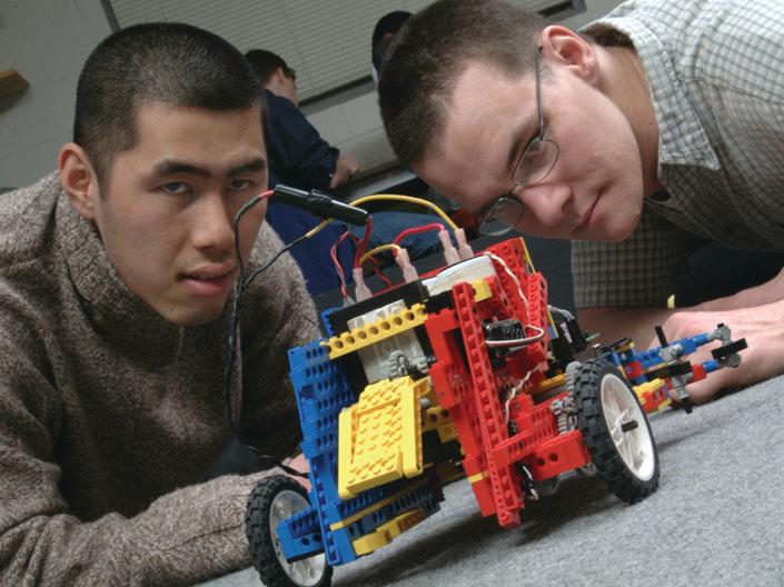 Two Case Western Reserve University students working on an electronic lego car